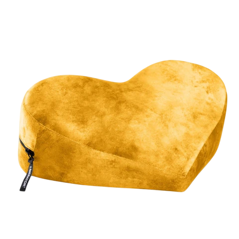 A yellow heart-shaped positioning pillow with a zipper and a tag.