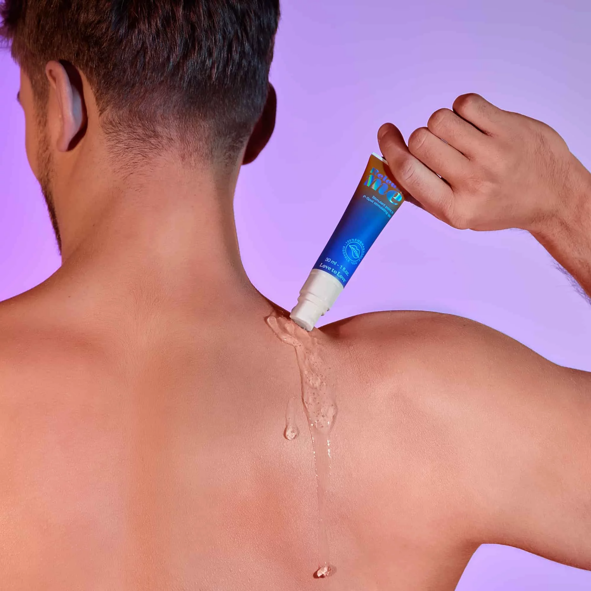 A hand squeezes a tube of stimulating gel onto a person's shoulder.