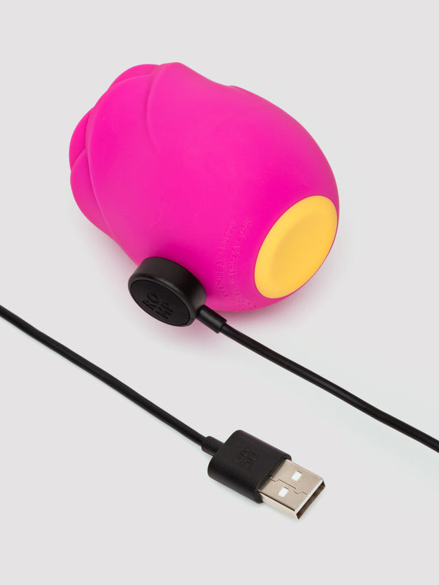 A pink rose-shaped clitoral stimulator with a yellow tip and a USB charging cable.