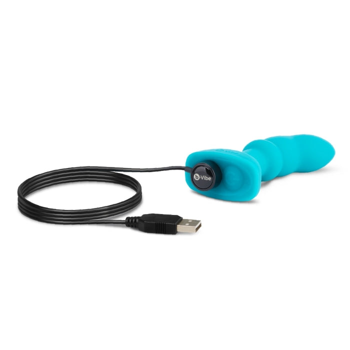 A teal silicone remote-controlled P-spot plug with a USB charging cable.