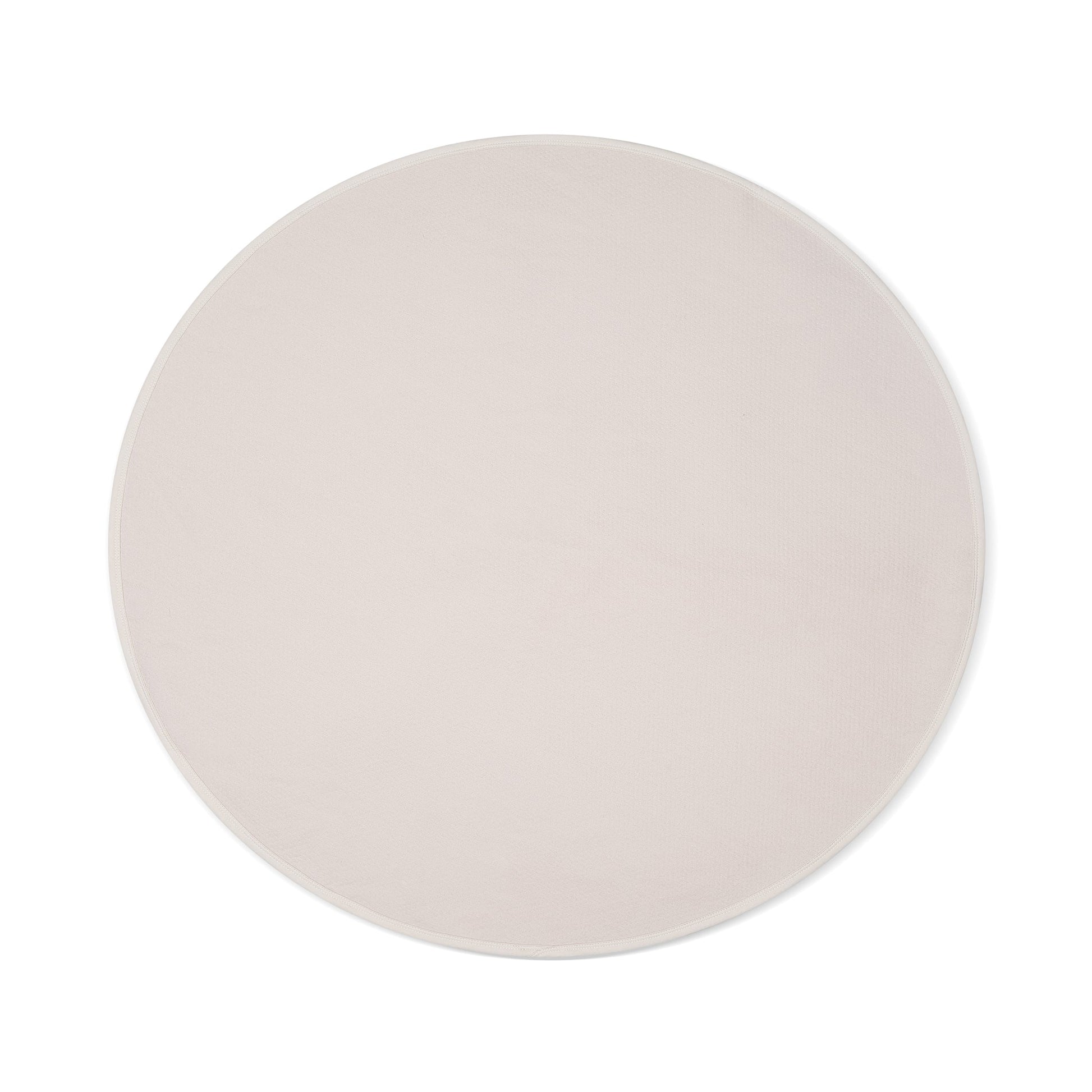 Circular oat-colored waterproof throw blanket with a textured surface.