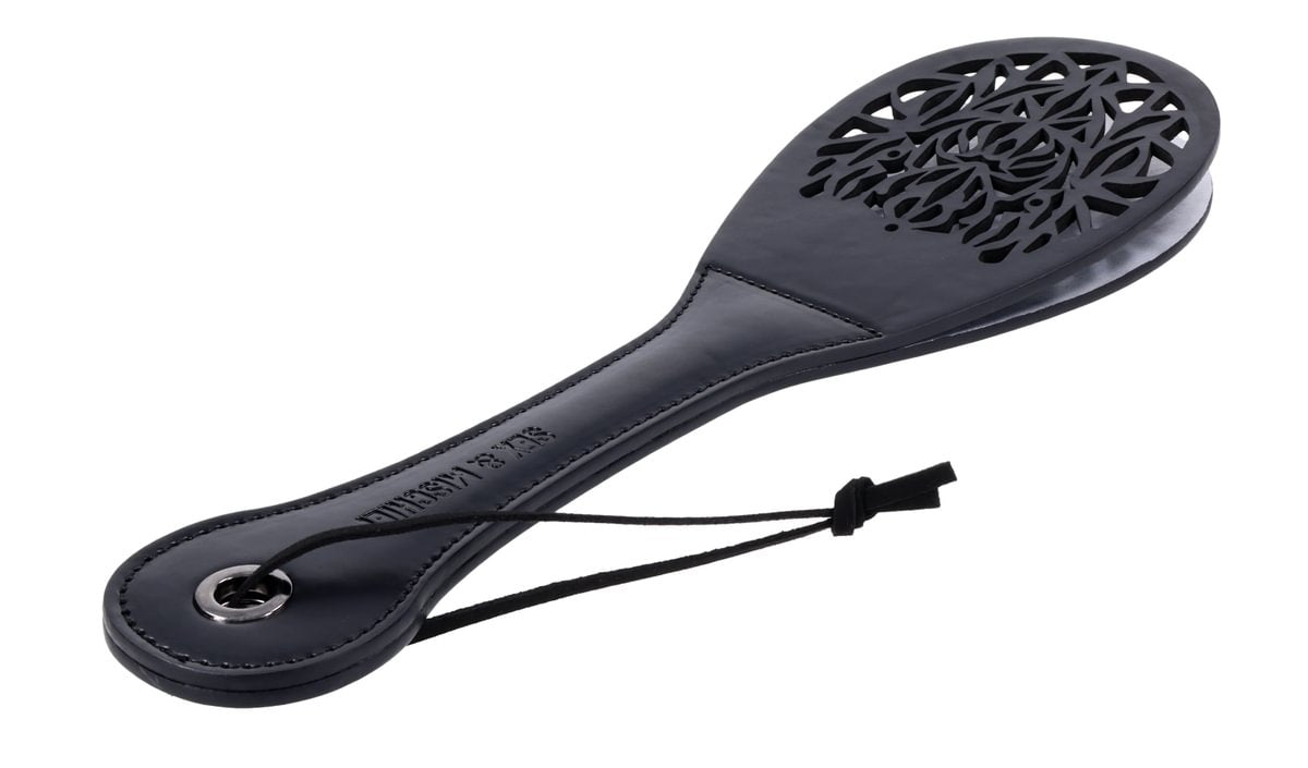 Black faux leather spanker paddle with a lace cutout and split tip.