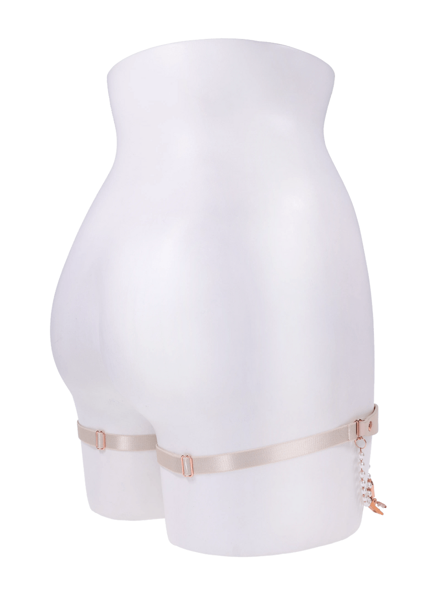 Pearl garter set with faux leather and rose gold hardware on a mannequin.