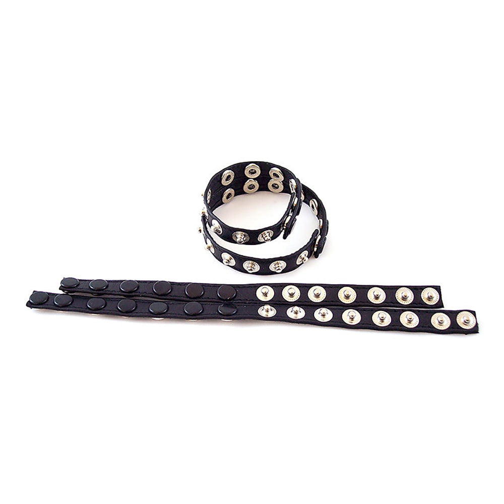Black leather cock strap with double snap closure and silver studs.