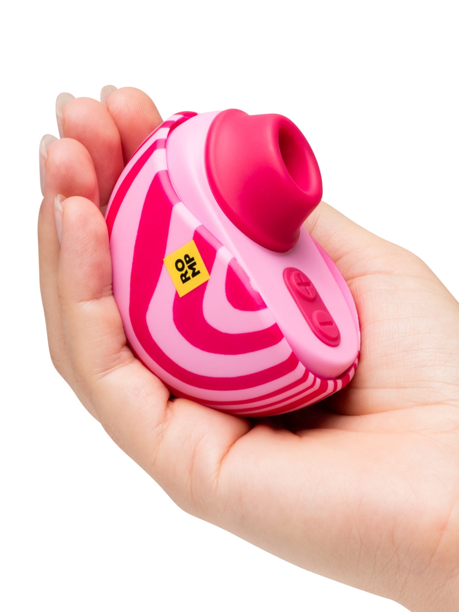 A pink and white striped suction toy held in a hand.