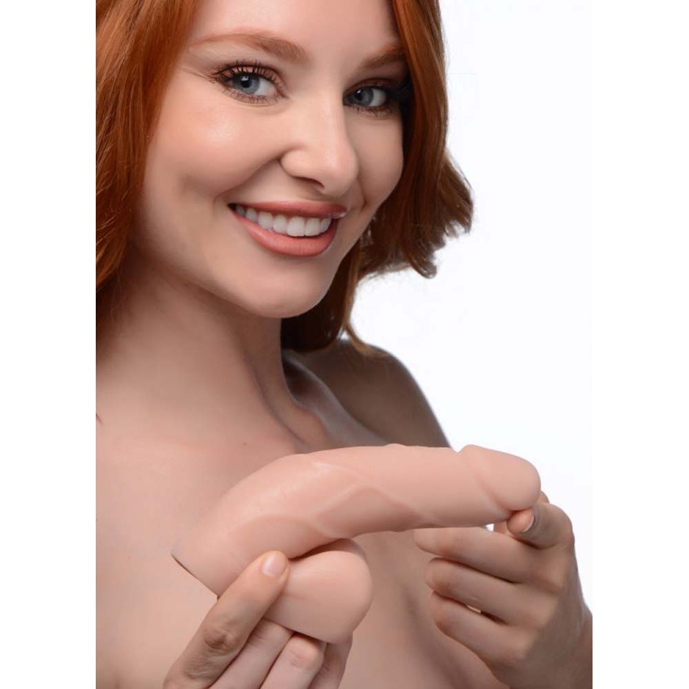 A light-toned, soft packer dildo with realistic veins.