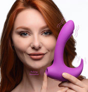 A woman holds a purple G-spot rabbit vibrator with a curved shaft and tendrils.