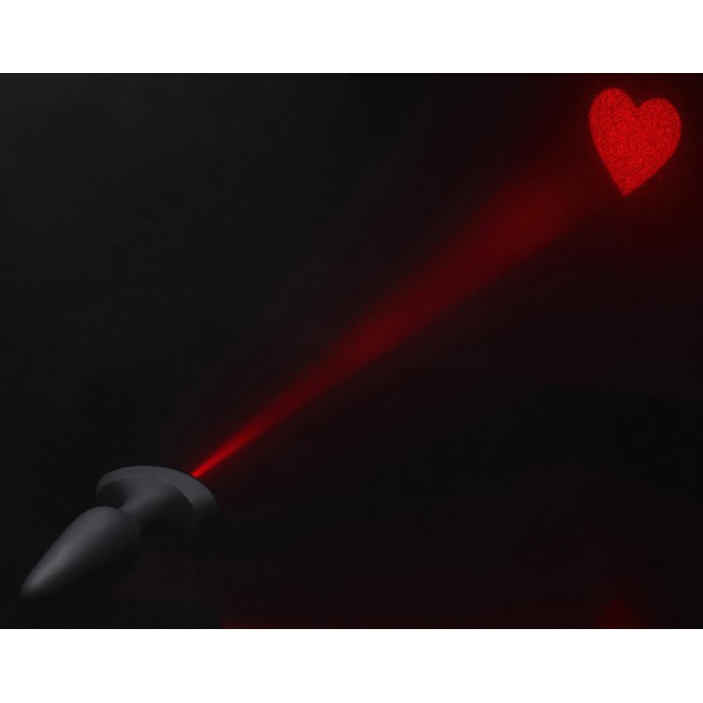 Black silicone anal plug projecting a red laser heart.