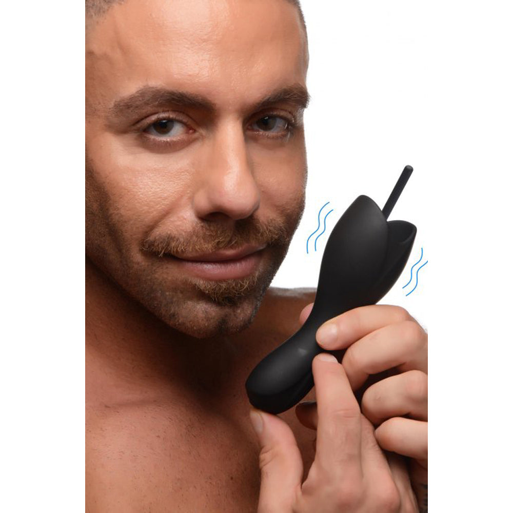 Man holding a black vibrating urethral sound teaser.