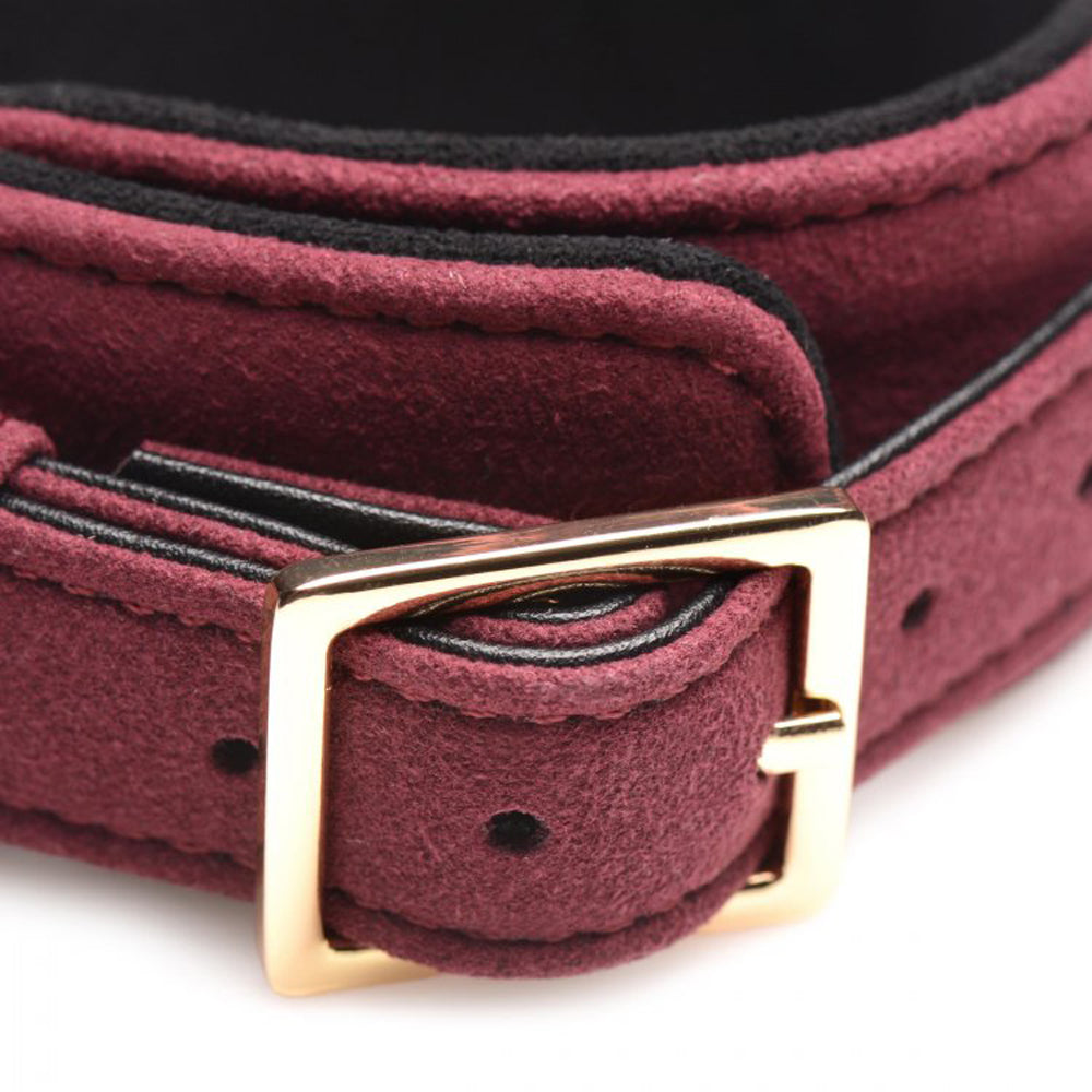 Burgundy velvet cuff with gold buckle and black trim.