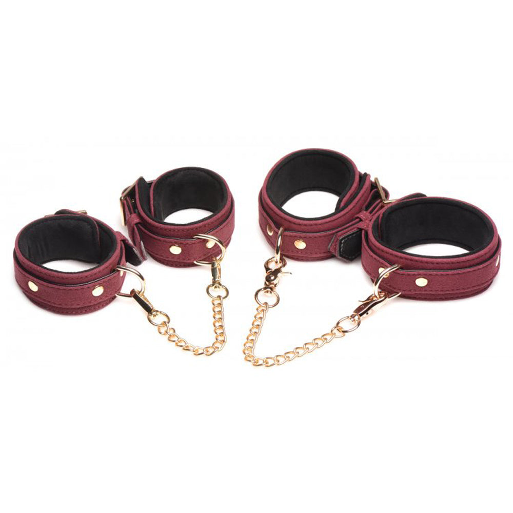 Burgundy velvet and vegan leather cuffs with gold chains.
