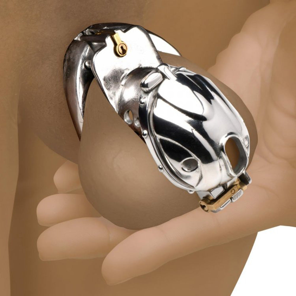 Stainless steel locking chastity cage with a gold lock and key.