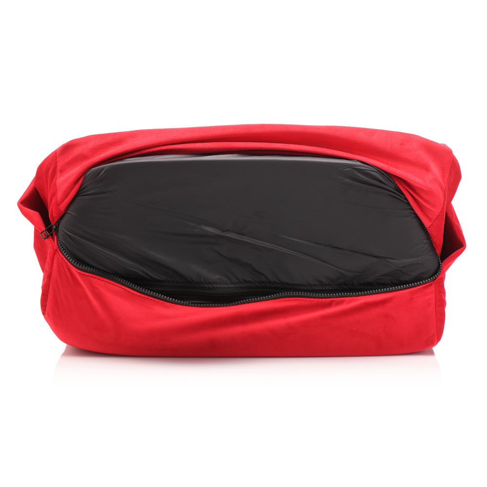 Red wedge pillow with a black inner lining and zipper.