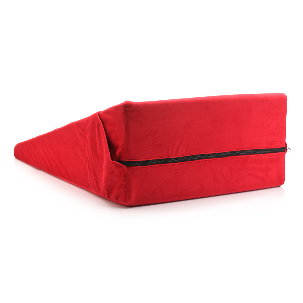 Red wedge pillow with a zipper closure.