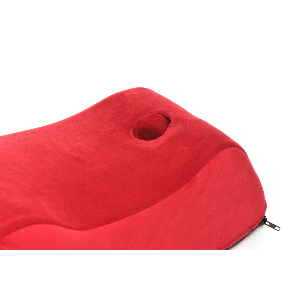 Red foam positioning pillow with a hole and a zipper.