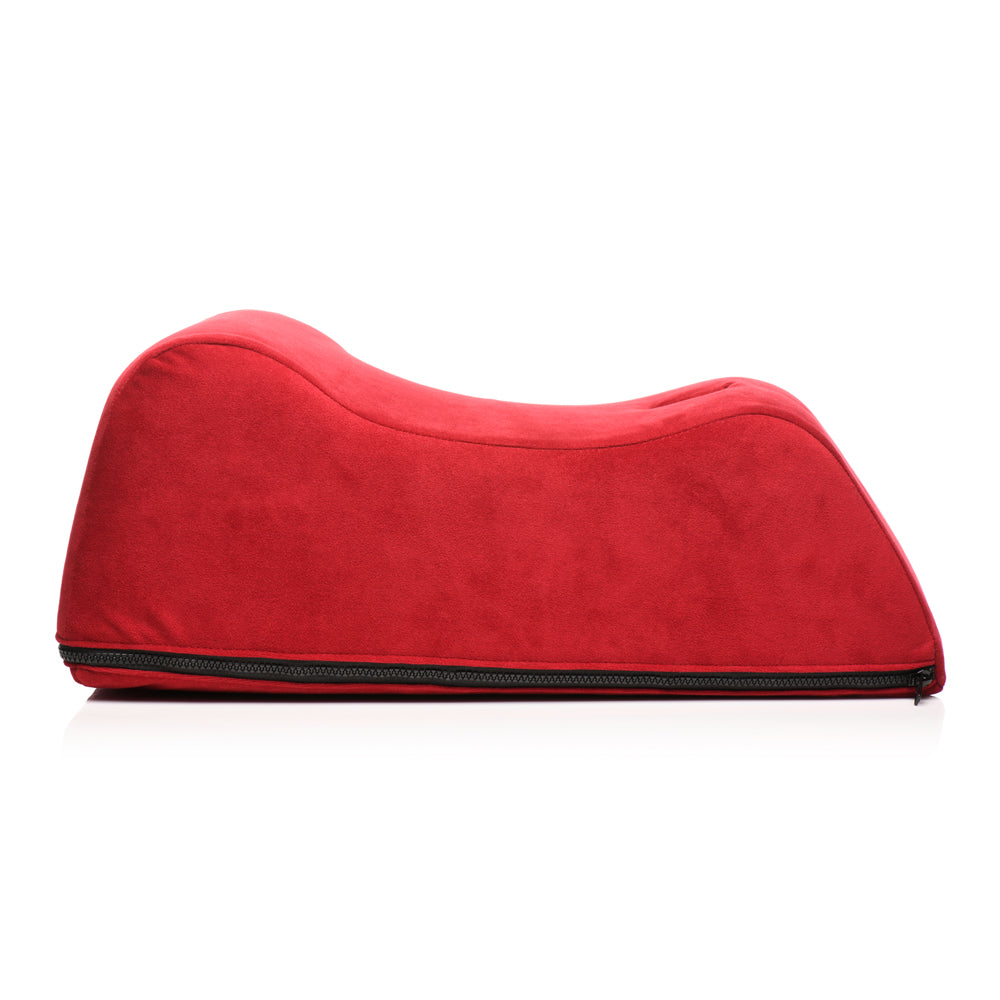 Red foam positioning pillow with a curved shape and a visible zipper.