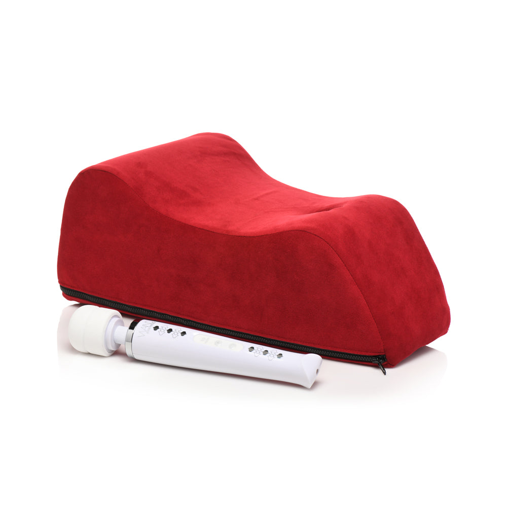 Red foam positioning pillow with a white wand vibrator.