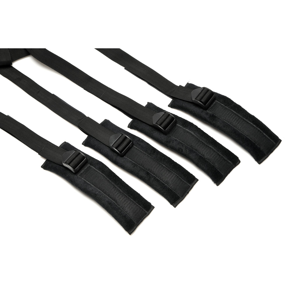 Black padded bed restraints with adjustable straps and buckles.