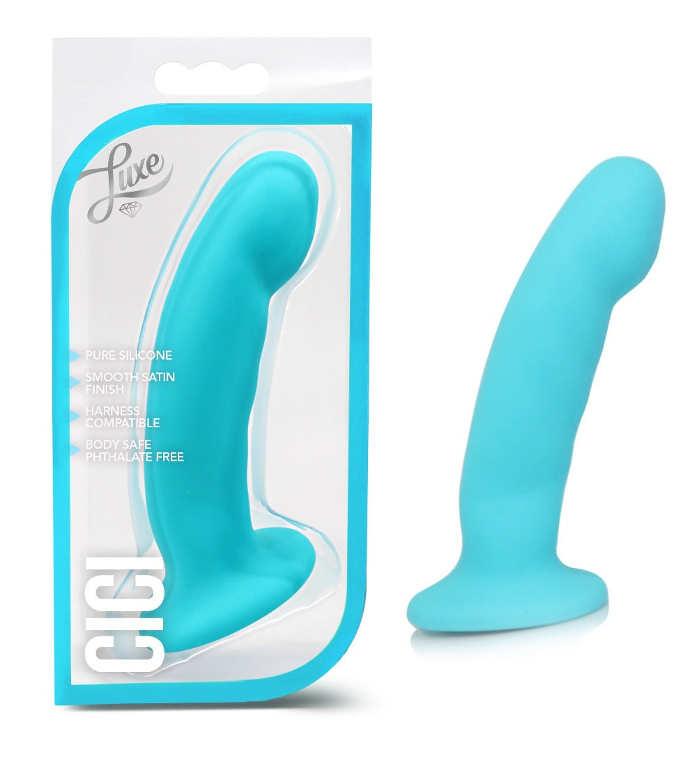 Blue silicone harness dildo with satin finish on white packaging.