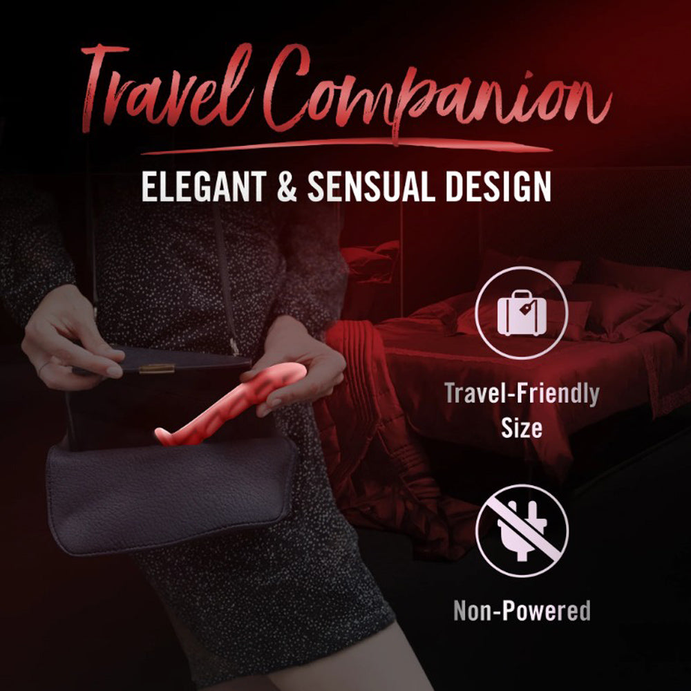 Red silicone G-spot dildo with a curved tip, held by hands near a purse.
