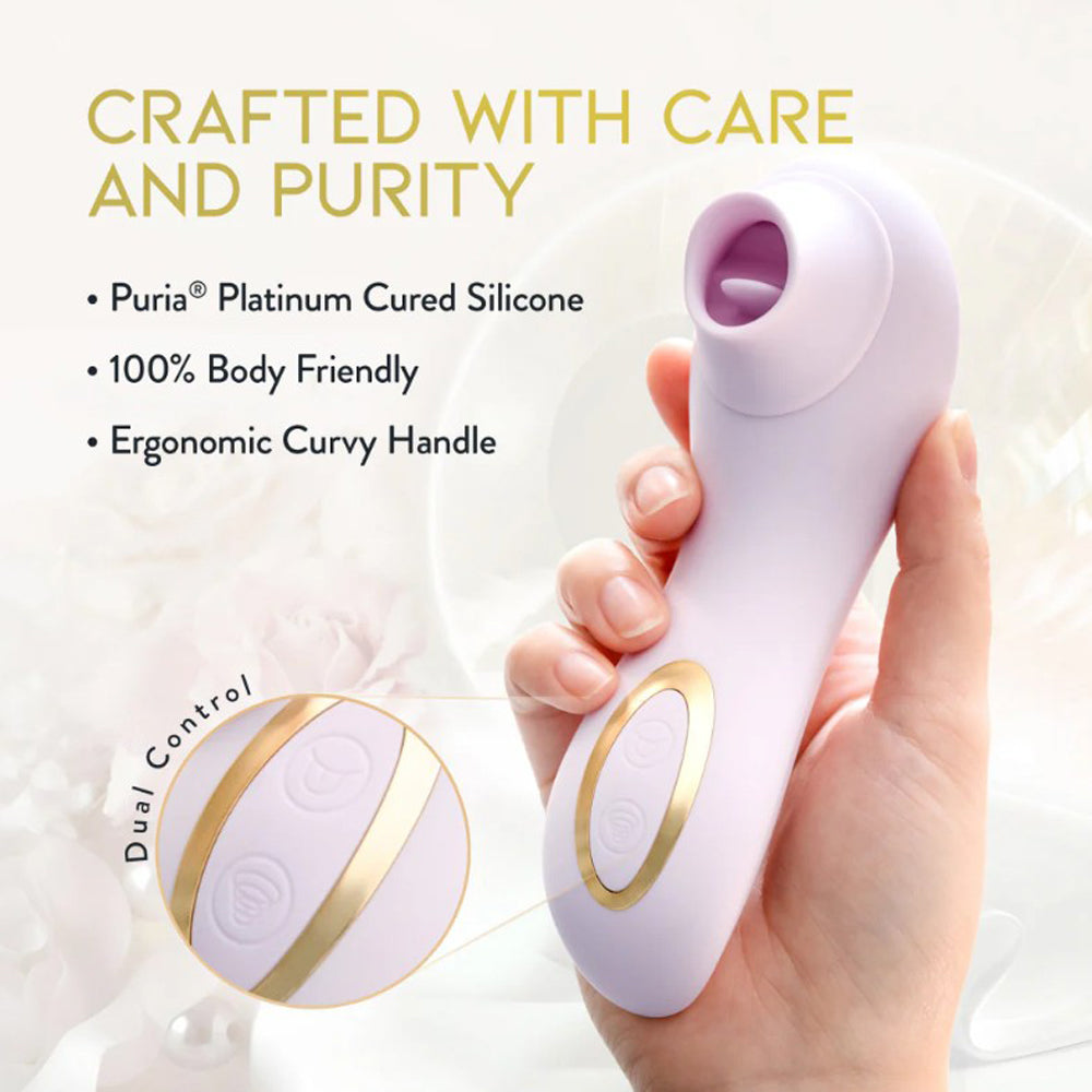 A blush-colored silicone massager with dual control buttons and gold accents.