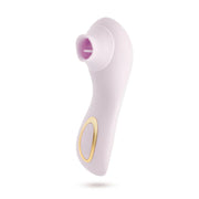 A blush silicone clitoral massager with a suction opening and gold accent buttons.