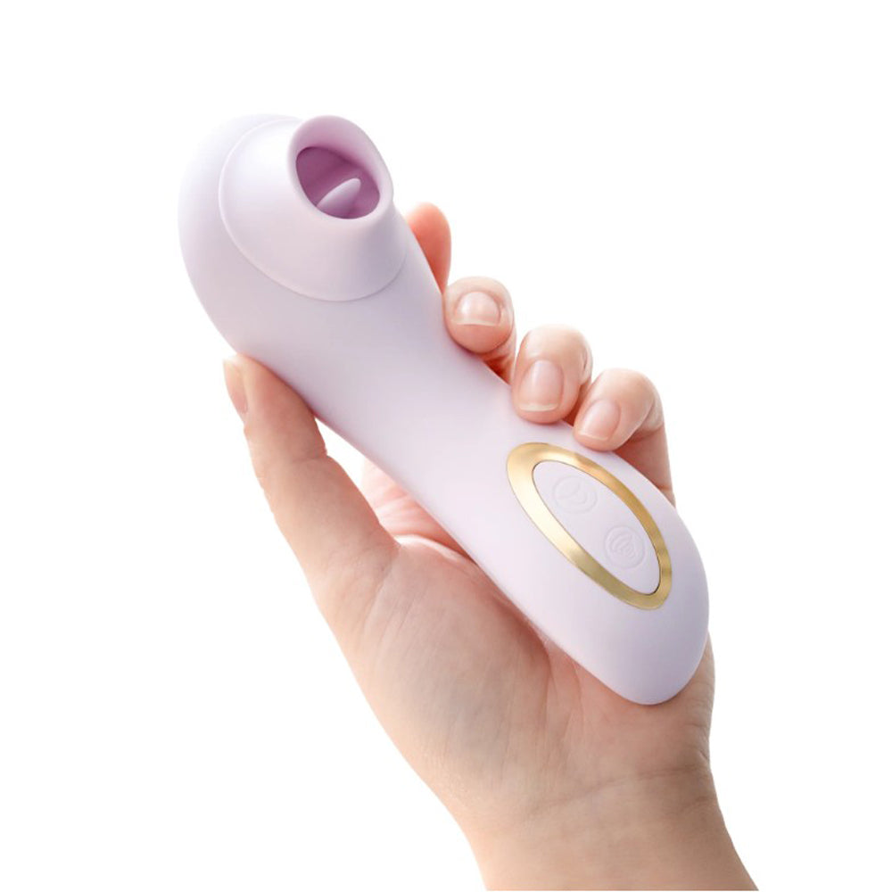 A hand holds a blush-colored clitoral suction and fluttering silicone massager.