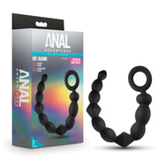 Black silicone anal beads with a looped handle on a white background.