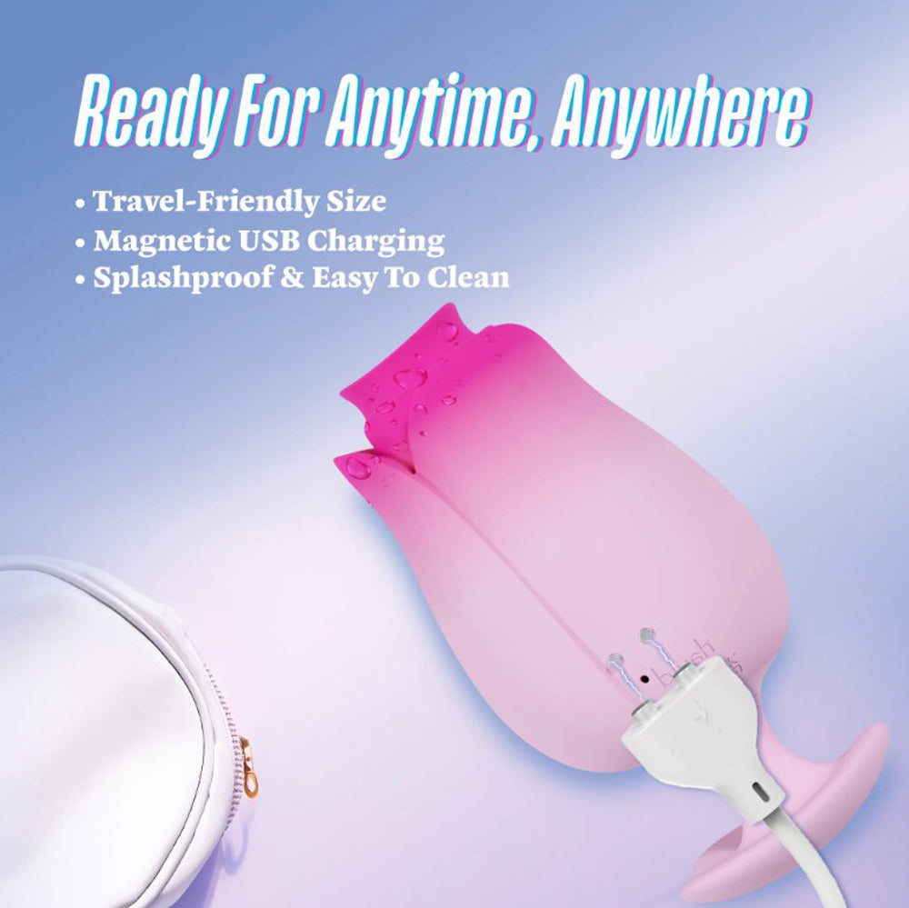 Pink tulip-shaped massager with a charging cable and a white pouch.