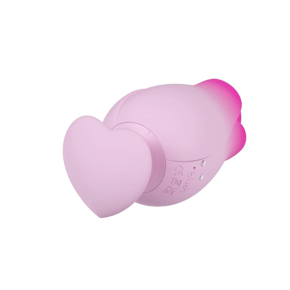 Pink silicone massager with a heart-shaped base and pink accents.