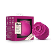A pink rose-shaped massager with air pulsation, made of silicone.