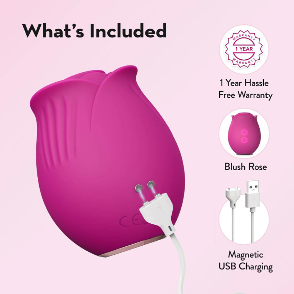 A pink rose-shaped massager with a USB charging cable and warranty information.