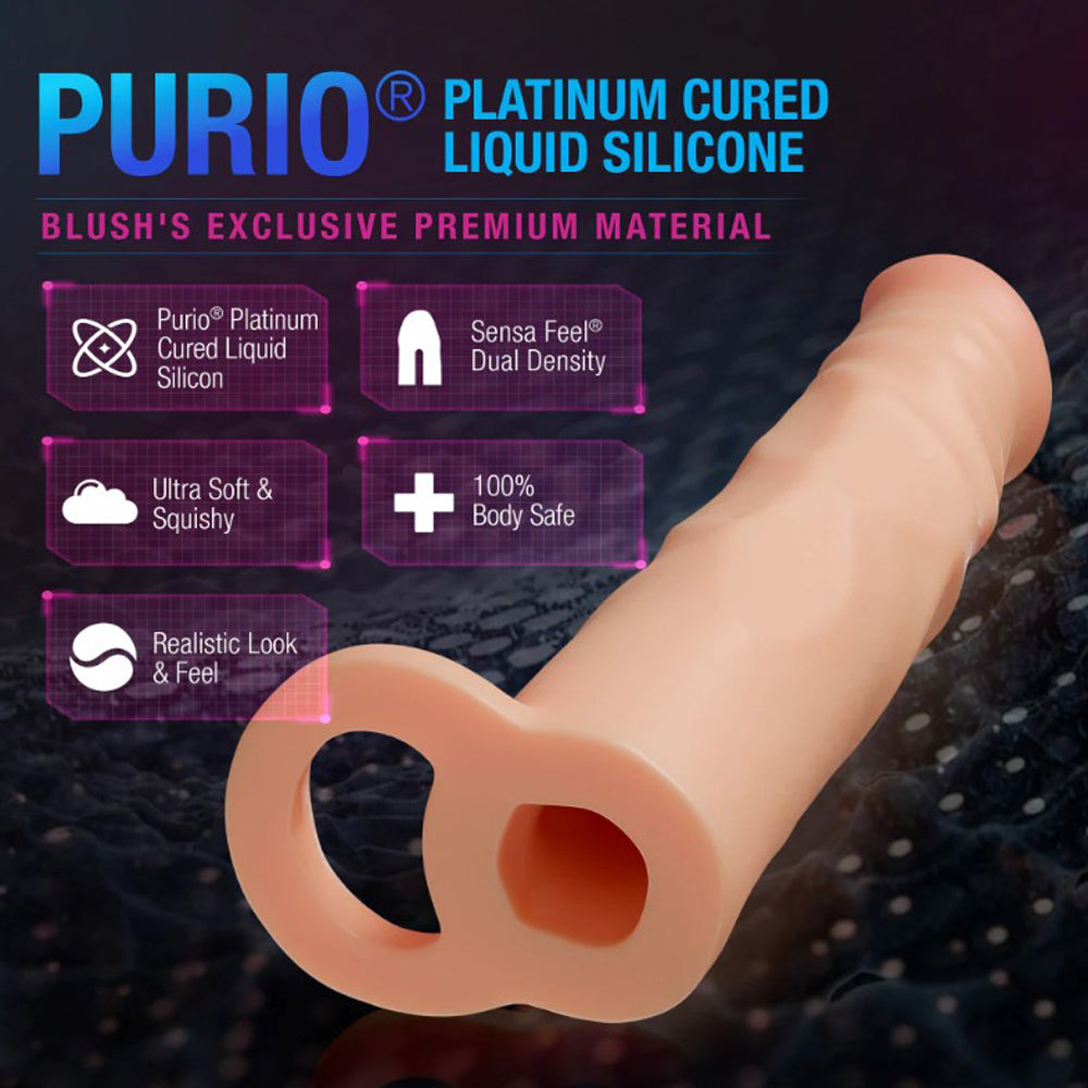 A beige silicone penis extender with a dual-density design and ball strap.