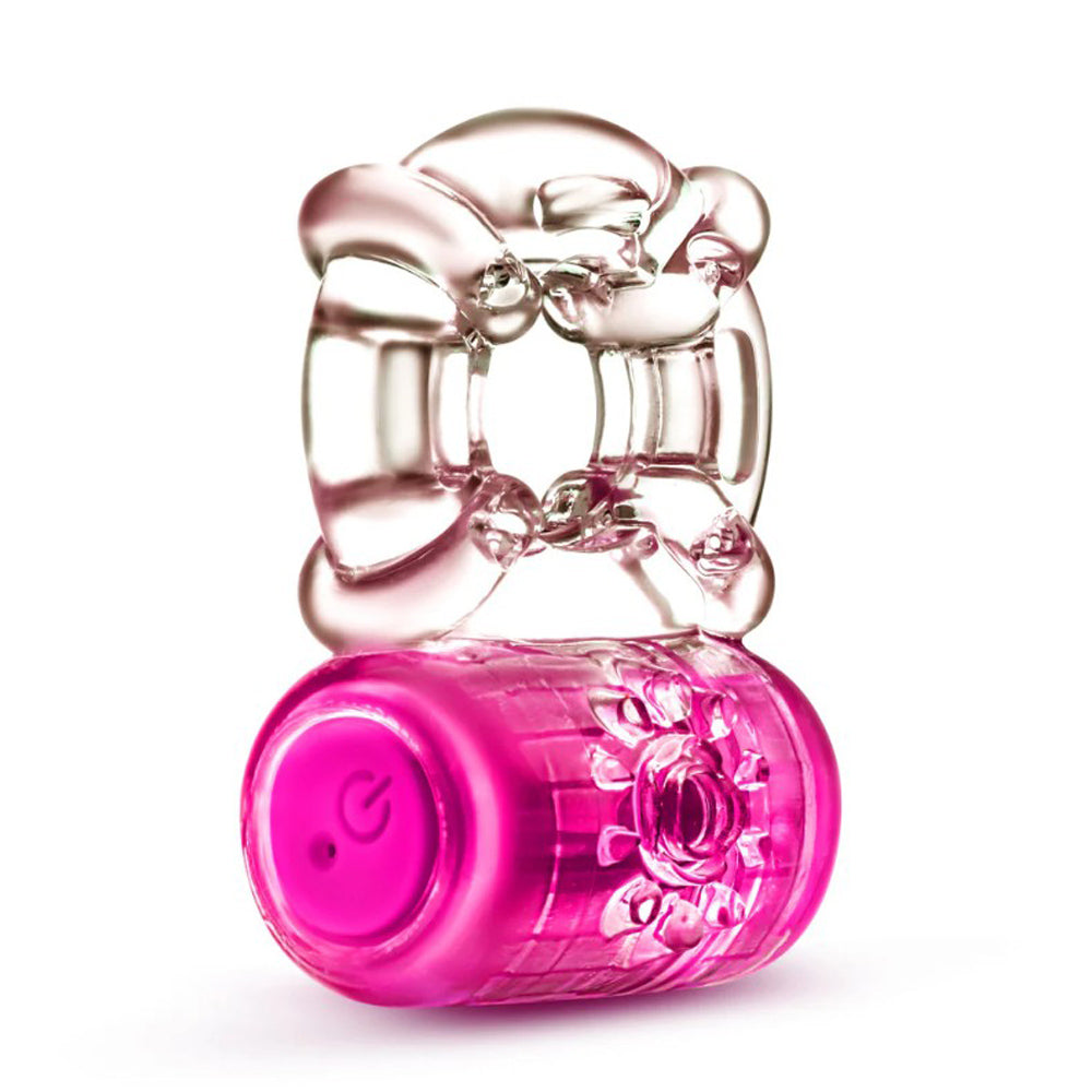 A pink vibrating C-ring with a clear top and a power button.