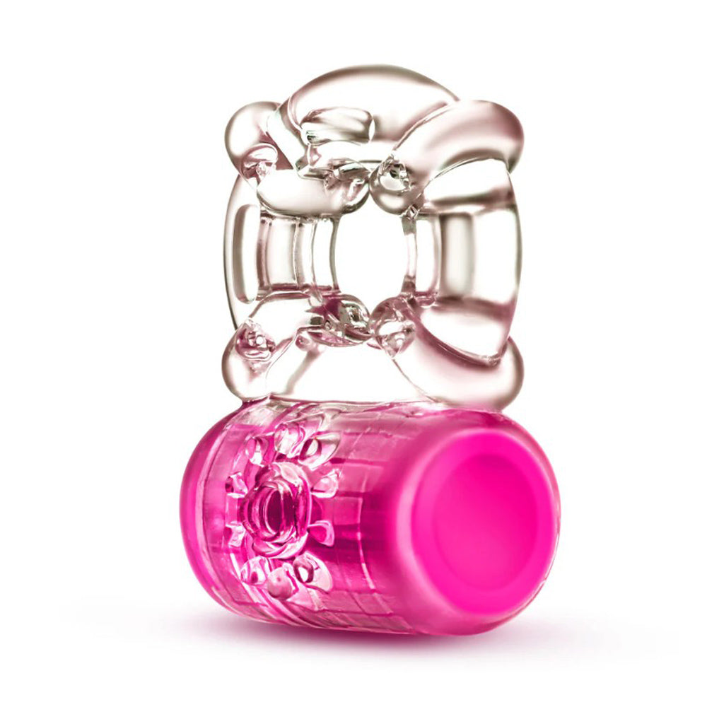 A clear vibrating C-ring with a pink base and textured floral pattern.