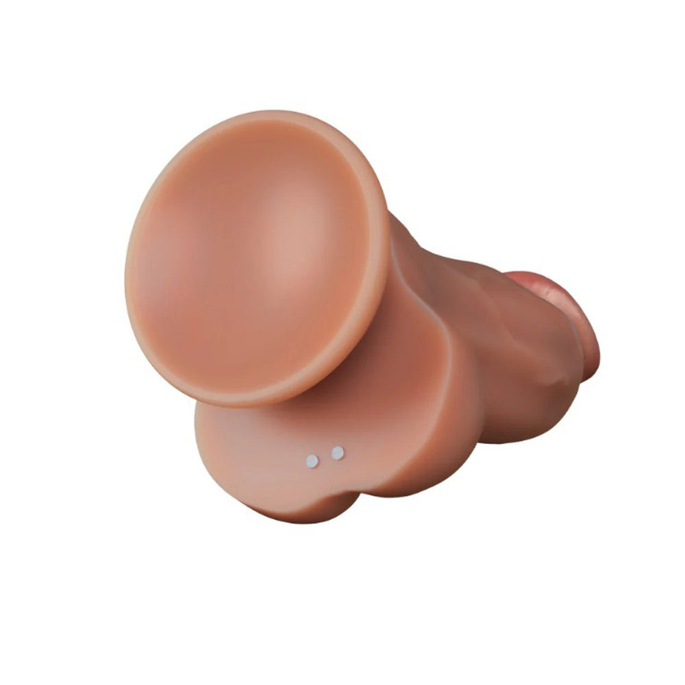 A tan silicone dildo with a textured shaft and two small white dots.