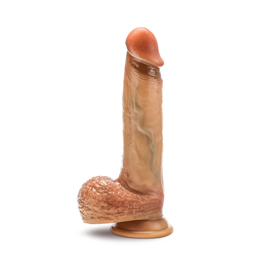 Realistic blush silicone dildo with sliding foreskin, balls, and suction cup base.