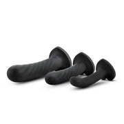 Three black silicone dildos of varying sizes with twisted textures and flared bases.