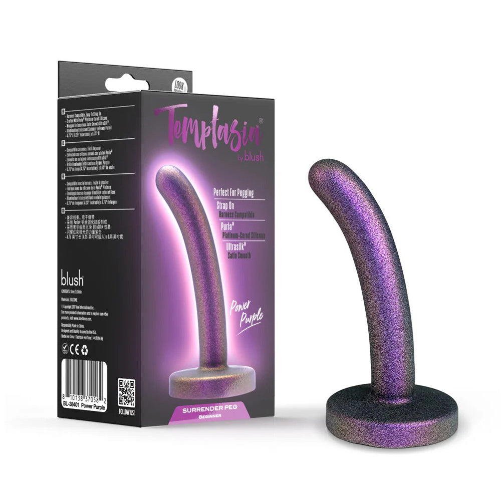 A purple glittery silicone dildo with a curved shape and a flared base, shown next to its packaging.