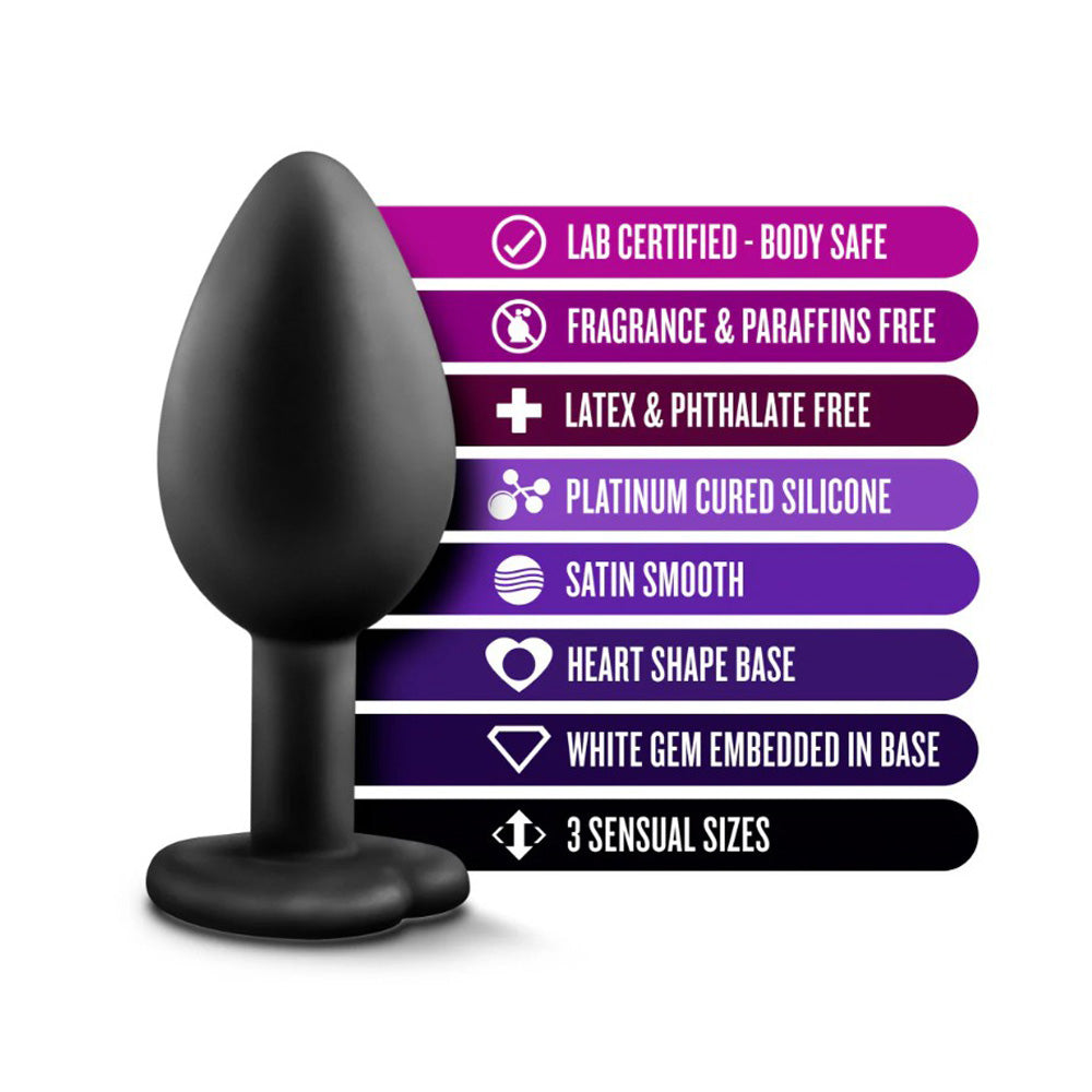 Black silicone anal plug with a heart-shaped base and white gem, featuring body-safe and platinum-cured silicone attributes.