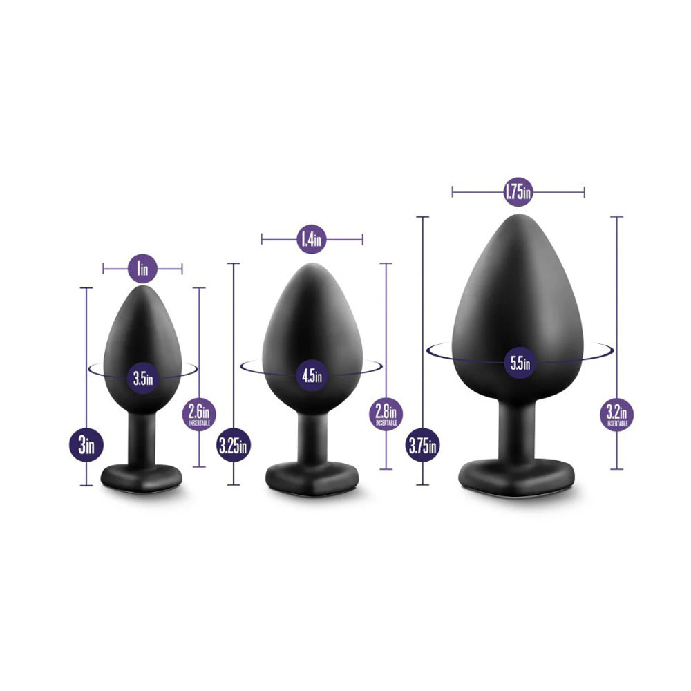 Three black silicone anal plugs of varying sizes with measurement indicators.