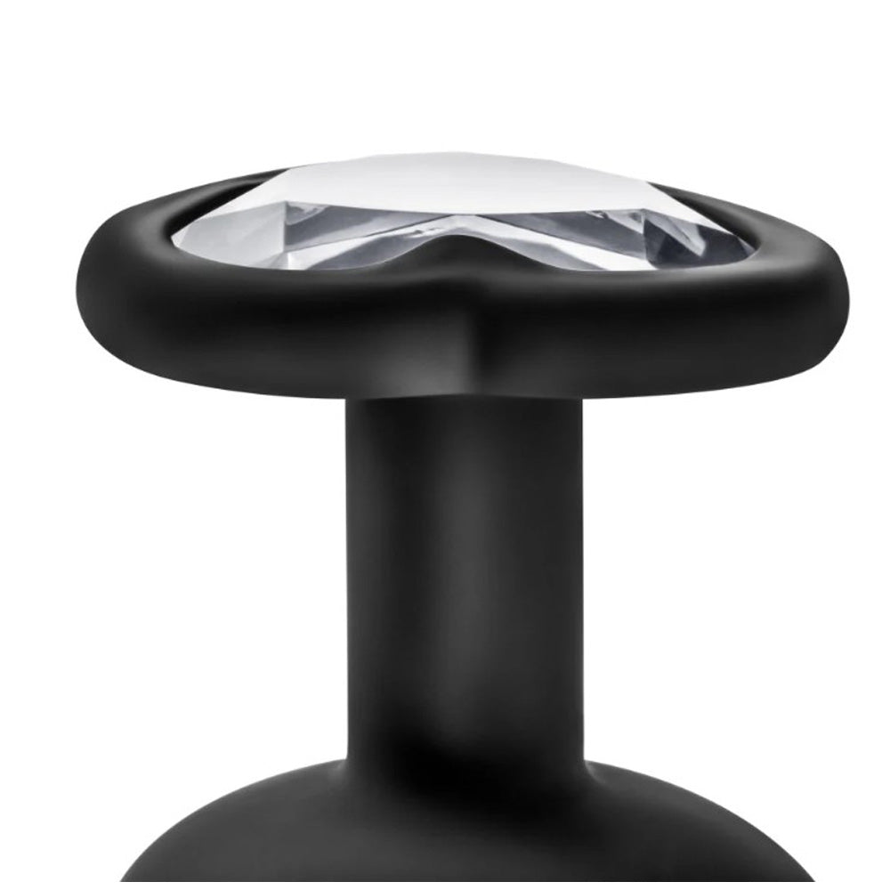 Black silicone anal plug with a white gem top.