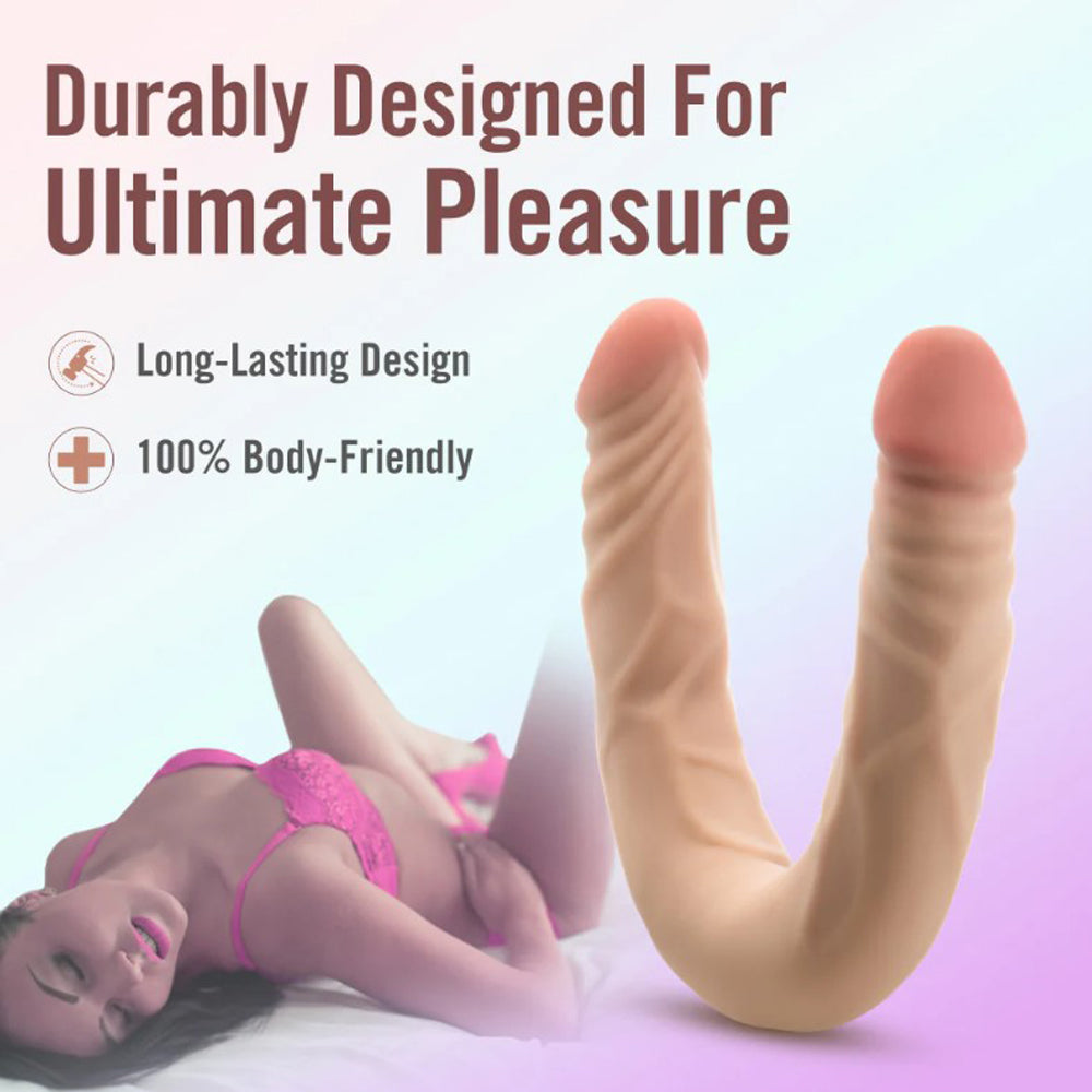 A 14-inch posable double-ended realistic TPE dildo in flesh tone, shown curved with a model.