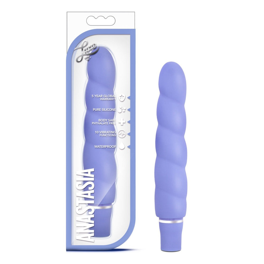 Purple ribbed silicone vibrator in periwinkle with packaging.