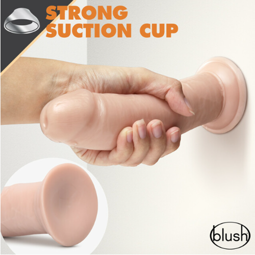 Realistic 8-inch TPE dildo with suction cup base, held by hand against a wall.