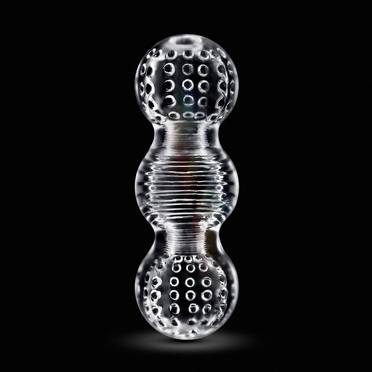 Clear stroker with textured spheres and ribbed middle section.