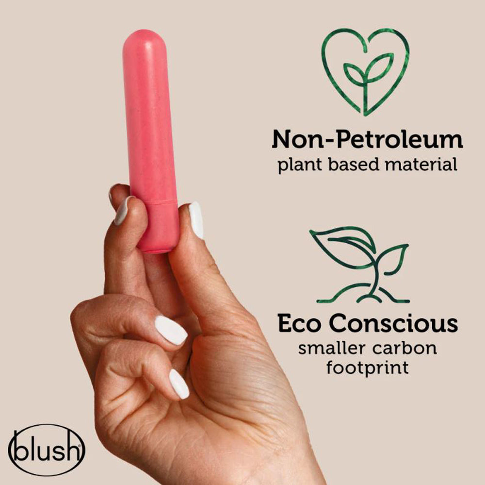 A pink, plant-based, biodegradable vibrator held by a hand.