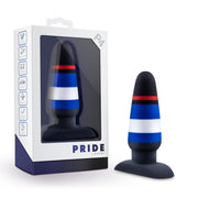 A black, blue, white, and red striped silicone dildo with a suction cup base in its packaging.