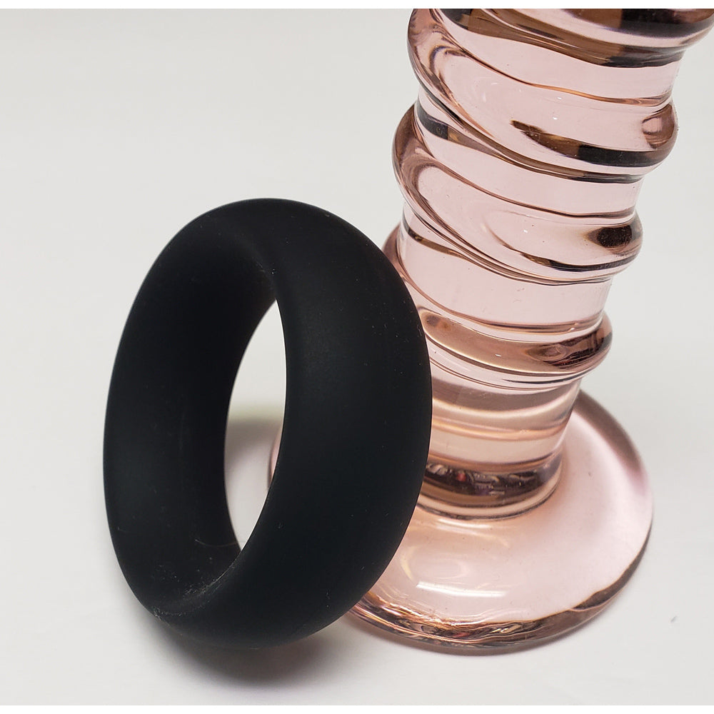 Black wide silicone cock ring.