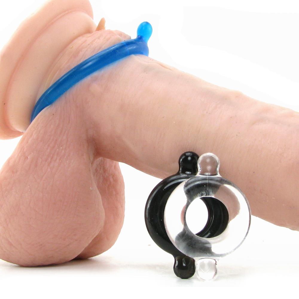 A set of three flexible elastomer cock rings in blue, black, and clear.